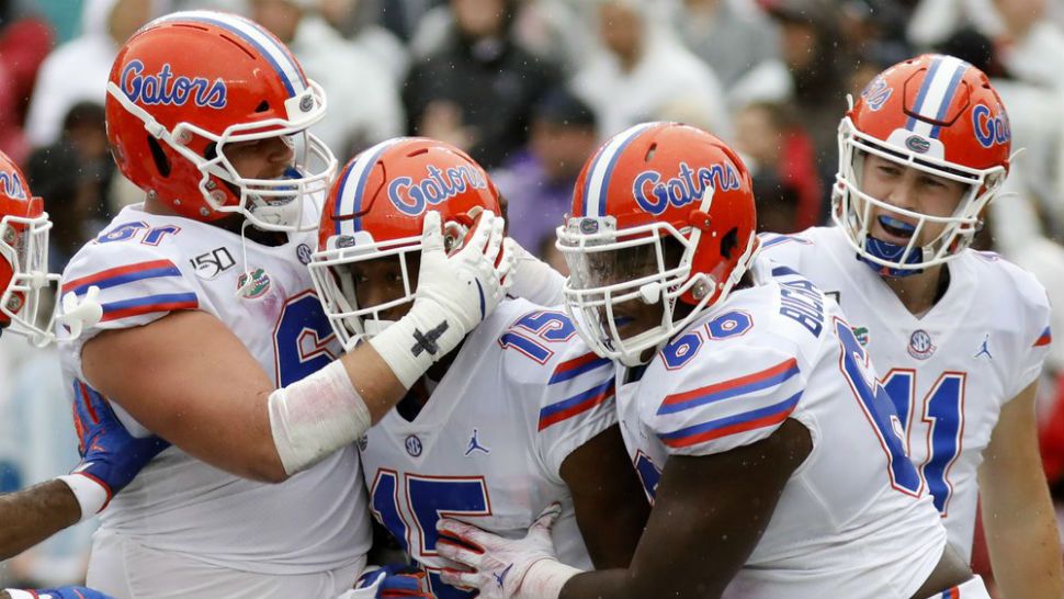 Florida's Jacob Copeland (15) is congratulated by teammates after scoring a touchdown against South Carolina in the first half of an NCAA college football game Saturday, Oct. 19, 2019, in Columbia, SC. (AP Photo/Mic Smith)