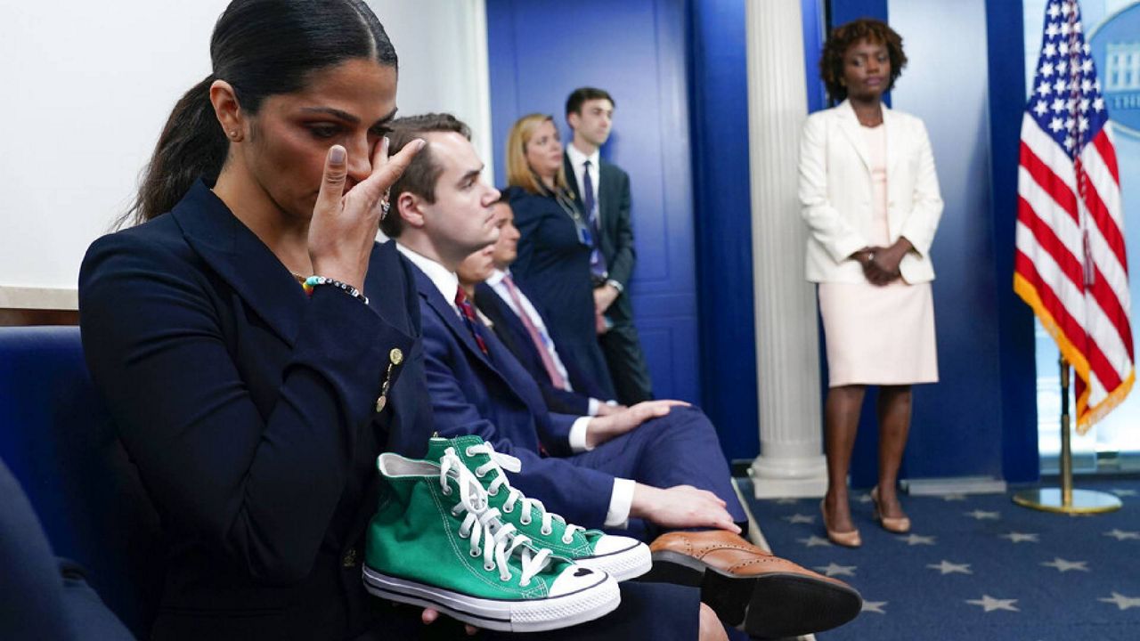 Camila Alves McConaughey holds a pair of green Converse tennis shoes similar to those worn by Uvalde shooting victim Maite Yuleana Rodriguez, 10, as her husband Matthew McConaughey, a native of Uvalde, Texas, joins White House press secretary Karine Jean-Pierre for the daily briefing at the White House in Washington, Tuesday, June 7, 2022. McConaughey said at the press briefing that his wife was holding a pair of sneakers worn by the girl. The shoes were similar, but they were not the girl’s sneakers. (AP Photo/Susan Walsh)