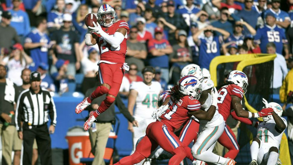 Buffalo Bills safety Micah Hyde, left, soars high to recover an on-side kickoff by the Miami Dolphins, which he ran back for a touchdown in the second half of an NFL football game, Sunday, Oct. 20, 2019, in Orchard Park, N.Y. (AP Photo/Adrian Kraus)
