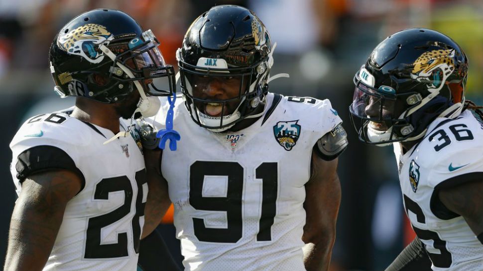 Jacksonville Jaguars defensive end Yannick Ngakoue (91) celebrates his interception and touchdown run in the second half of an NFL football game against the Cincinnati Bengals, Sunday, Oct. 20, 2019, in Cincinnati. (AP Photo/Gary Landers)