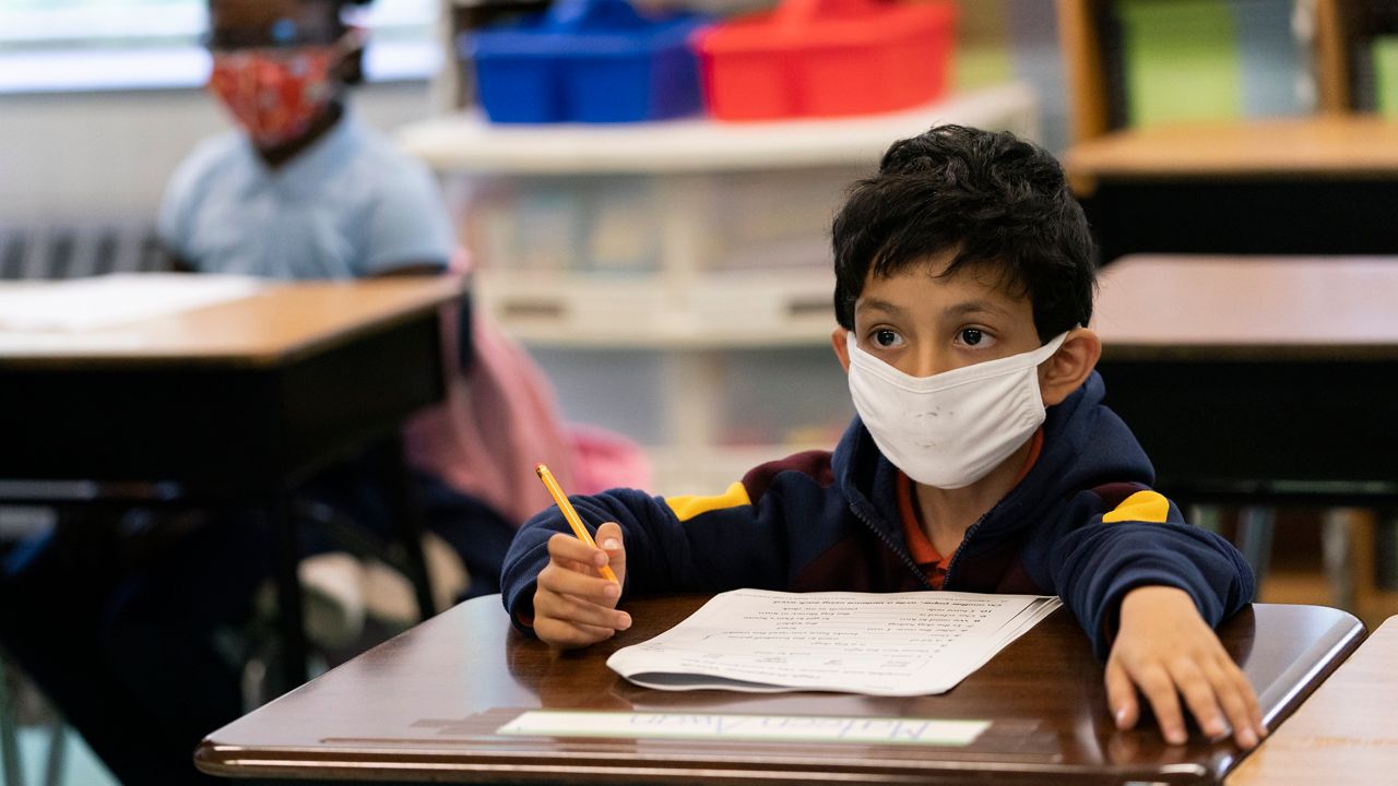 A student wears a face masks inside a classroom (Courtesy Associated Press)