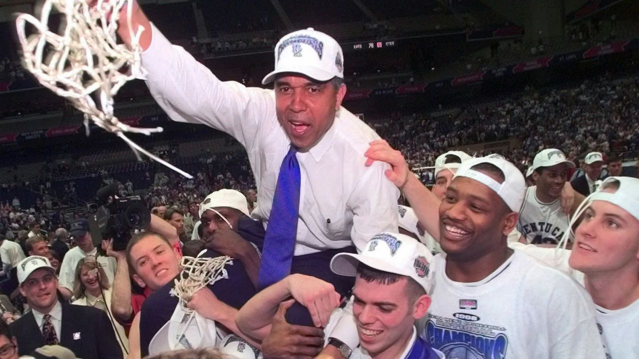 Kentucky Coach Tubby Smith is carried off the court by game MVP Jeff Sheppard, left, Steve Masiello, center right, and Jamaal Maglioire second from right front at the Alamodome in San Antonio Monday, March 30, 1998. Other players, cheerleaders and fans surround. (AP Photo/Eric Draper)