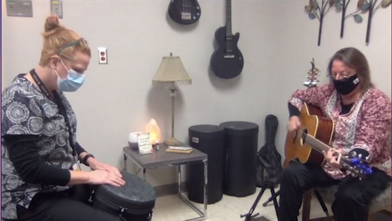 Two women playing guitars