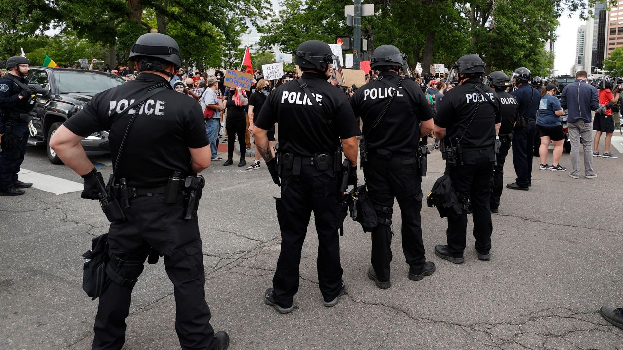 In this file photo from May 29, 2020, Denver Police officers square off with participants in a protest over the death of George Floyd by police officers in Minneapolis. (David Zalubowski/AP)