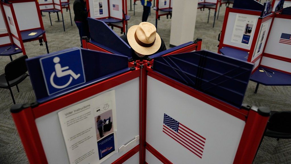 Rod Sommer stands in a partitioned booth and fills out his ballot during early in-person voting at the Hamilton County Board of Elections in Cincinnati, Wednesday, Oct. 11, 2023. (AP Photo/Carolyn Kaster, File)