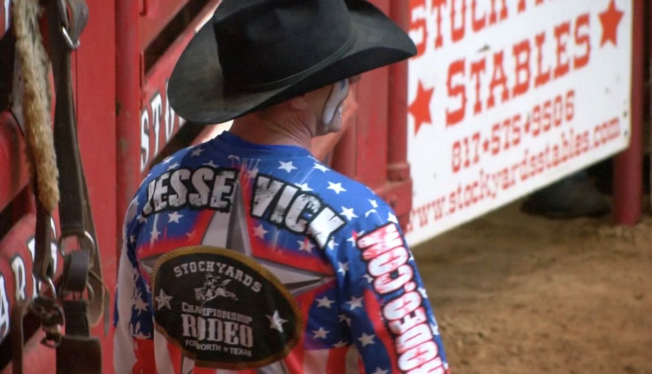 Rodeo bullfighting competitor Jesse Vick stands in the arena (Spectrum News)