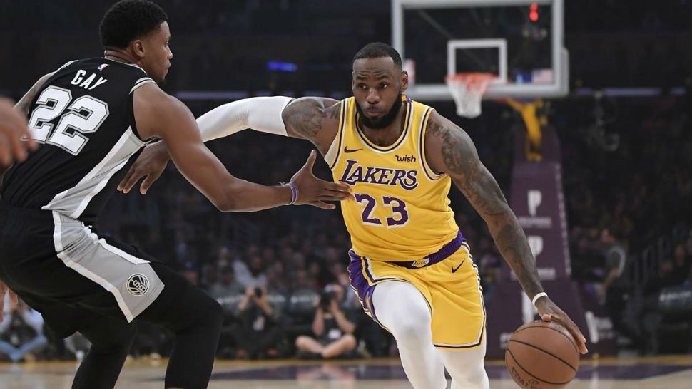 Los Angeles Lakers forward LeBron James, right, drives toward the basket as San Antonio Spurs forward Rudy Gay defends during the first half of an NBA basketball games Monday, October 22, 2018 in Los Angeles. (AP Photo/Mark J. Terrill)