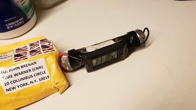A black device next to a yellow mail envelope.