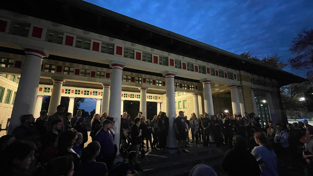Dozens gathered at Tower Grove Park in South St. Louis Monday night to mourn the school shooting earlier in the day which left two people dead and six injured. (Spectrum News/Gregg Palermo)