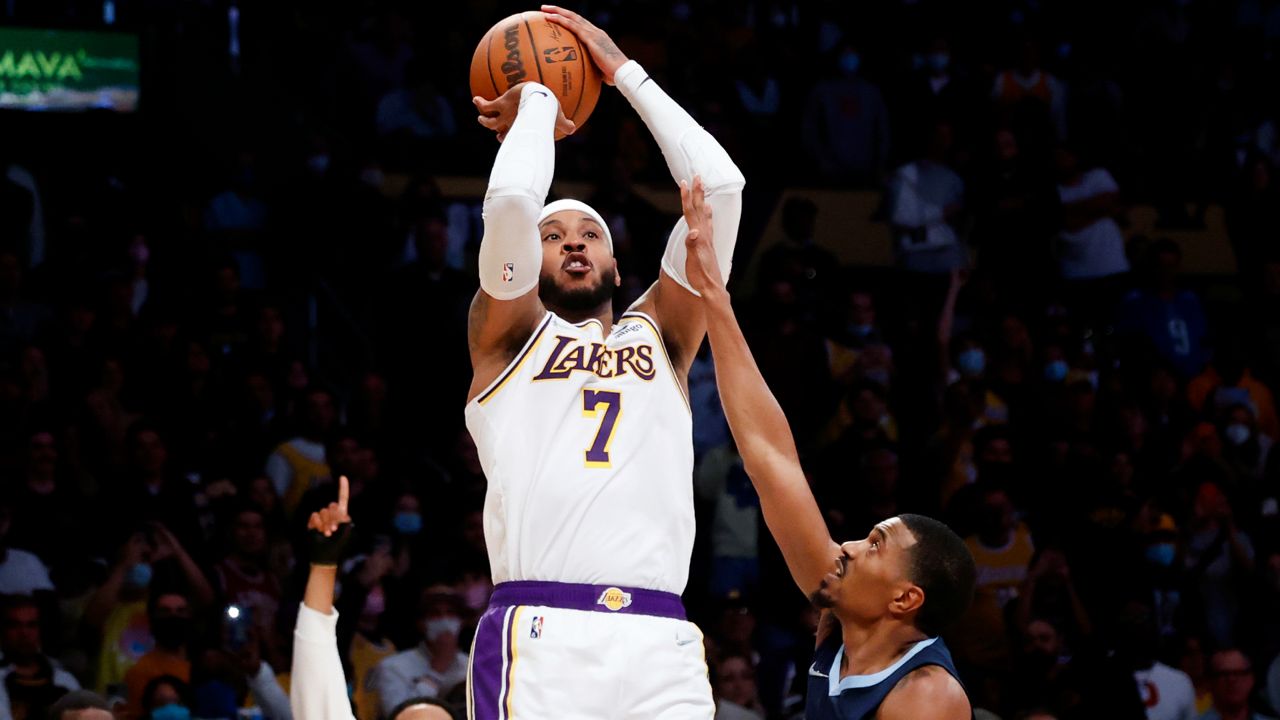 Los Angeles Lakers forward Carmelo Anthony (7) shoots over Memphis Grizzlies guard De'Anthony Melton (0) during the second half of an NBA basketball game in Los Angeles, Sunday, Oct. 24, 2021. The Lakers won 121-118. (AP Photo/Ringo H.W. Chiu)