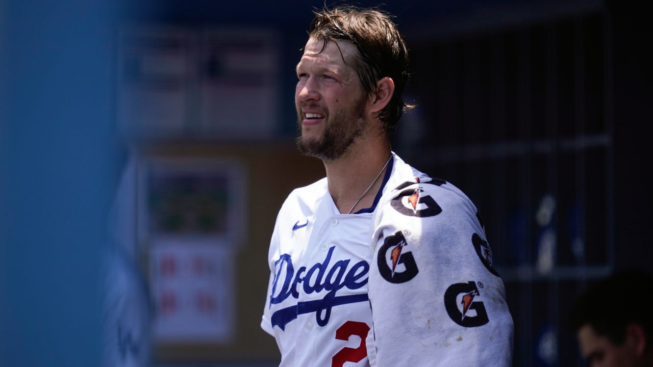 Los Angeles Dodgers starting pitcher Clayton Kershaw (22) ices his left arm in the dugout in the bottom of the first inning of a baseball game against the San Francisco Giants Sunday, May 30, 2021, in Los Angeles. (AP Photo/Ashley Landis)