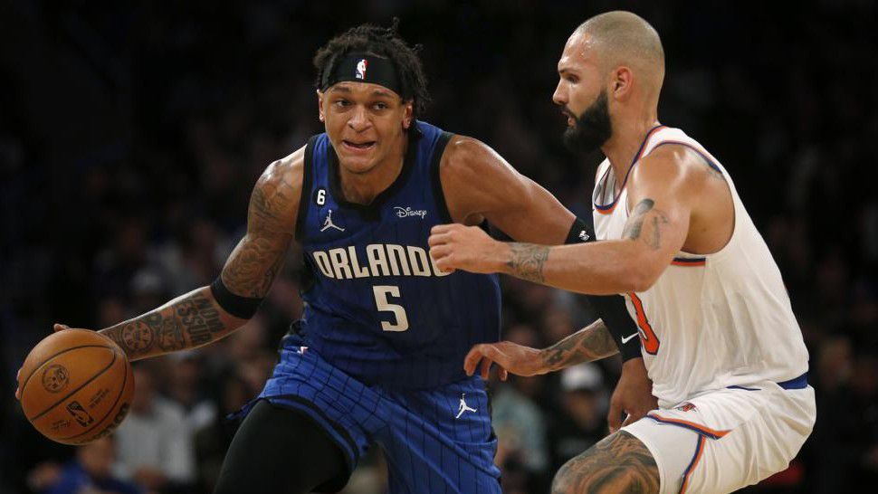 New York Knicks guard Evan Fournier, right, defends against Orlando Magic forward Paolo Banchero (5) during the first half of an NBA basketball game Monday, Oct. 24, 2022, in New York. (AP Photo/John Munson)