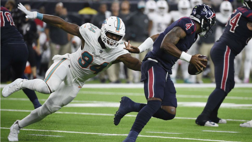 Houston Texans quarterback Deshaun Watson (4) is pressured by Miami Dolphins defensive end Robert Quinn (94) during the second half of an NFL football game, Thursday, Oct. 25, 2018, in Houston. (AP Photo/Eric Christian Smith)