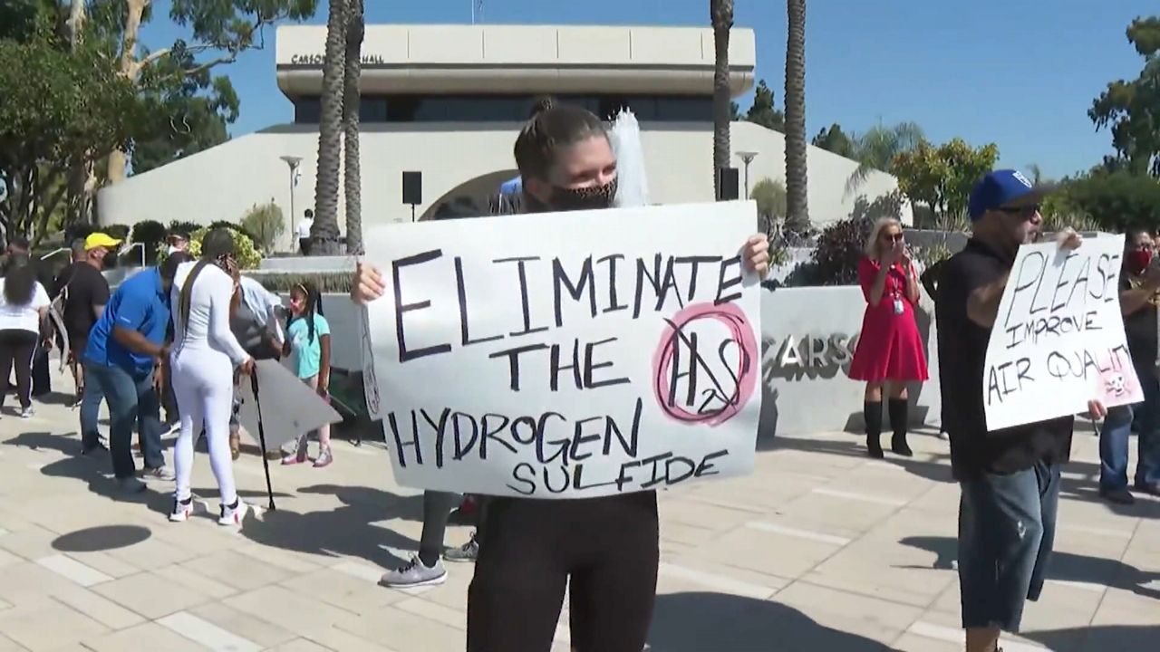 Carson residents rally in front of city hall for a solution to the odor problems emanating from the Dominguez Channel. (Spectrum News1)