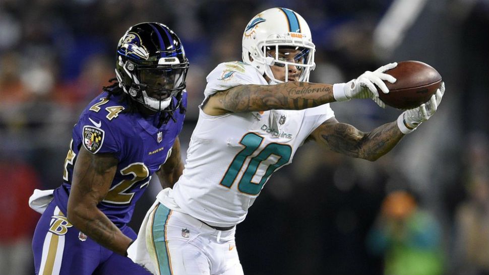 FILE - In this Oct. 26, 2017, file photo, Miami Dolphins wide receiver Kenny Stills (10) catches a pass in front of Baltimore Ravens cornerback Brandon Carr in the second half of an NFL football game in Baltimore. The Houston Texans continued a busy day of trades by addressing a glaring need to upgrade their offensive line by acquiring left tackle Laremy Tunsil from the Dolphins in a deal which also netted them receiver Kenny Stills, a source familiar with the deal tells The Associated Press. (AP Photo/Nick Wass, File)
