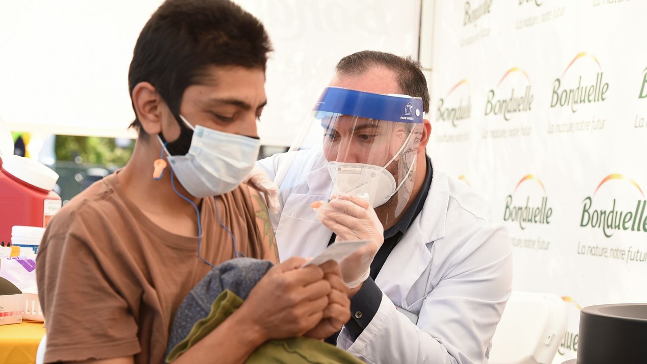 Paul Acosta, worker at the Irwindale Bonduelle facility, receives a COVID-19 vaccine at the company's on-site vaccination clinic for food and agriculture frontline heroes on Thursday, April 1, 2021 in Irwindale, Calif. (Jordan Strauss/Ready Pac Foods, Inc. via AP Images)