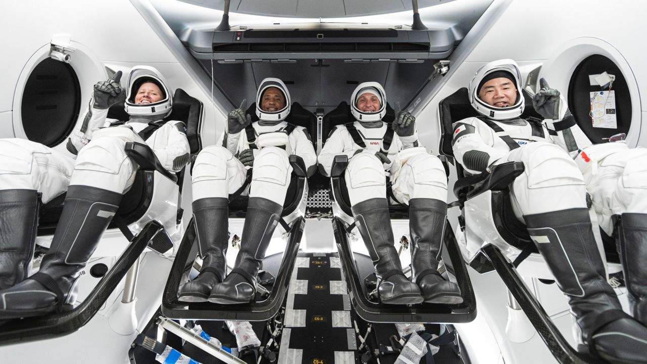 NASA astronauts Shannon Walker, Victor Glover, and Mike Hopkins and Japanese astronaut Soichi Noguchi pose inside a SpaceX Crew Dragon capsule during interface training. (SpaceX)