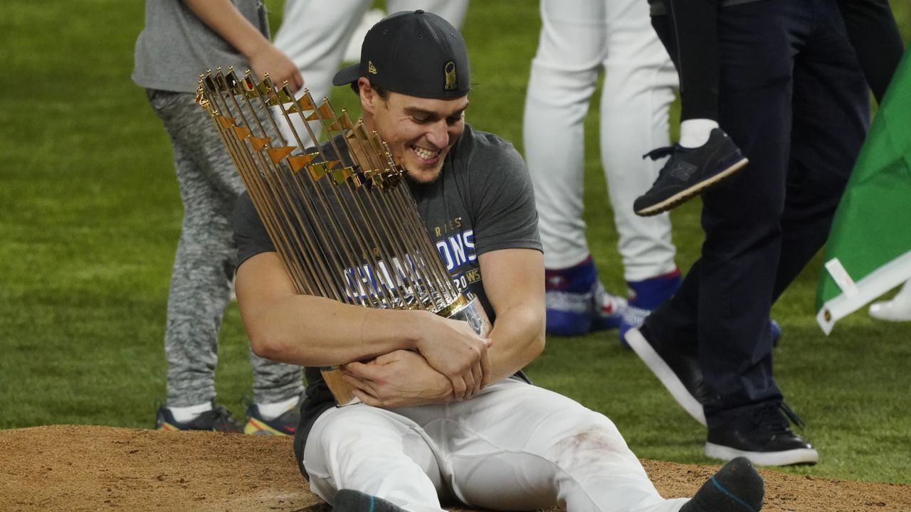 Los Angeles Dodgers second baseman Enrique Hernandez celebrates with trophy after defeating the Tampa Bay Rays 3-1 to win the World Series in Game 6 Tuesday, Oct. 27, 2020, in Arlington, Texas. (AP Photo/Tony Gutierrez)