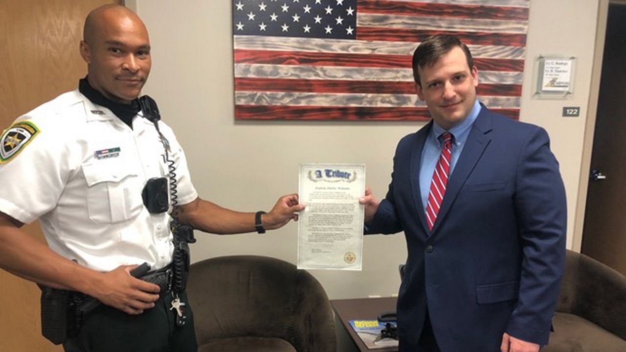 Deputy Charles Williams poses with State Rep. Mike Beltran after being honored by the Florida House of Representatives. (Josh Rojas, Spectrum News)