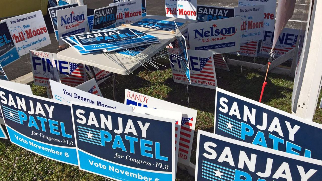 Two tables at an early voting location in Palm Bay, each belonging to opposing political parties, are unusable because they were blocked by signs from the opposition. (Krystel Knowles/Spectrum News 13)