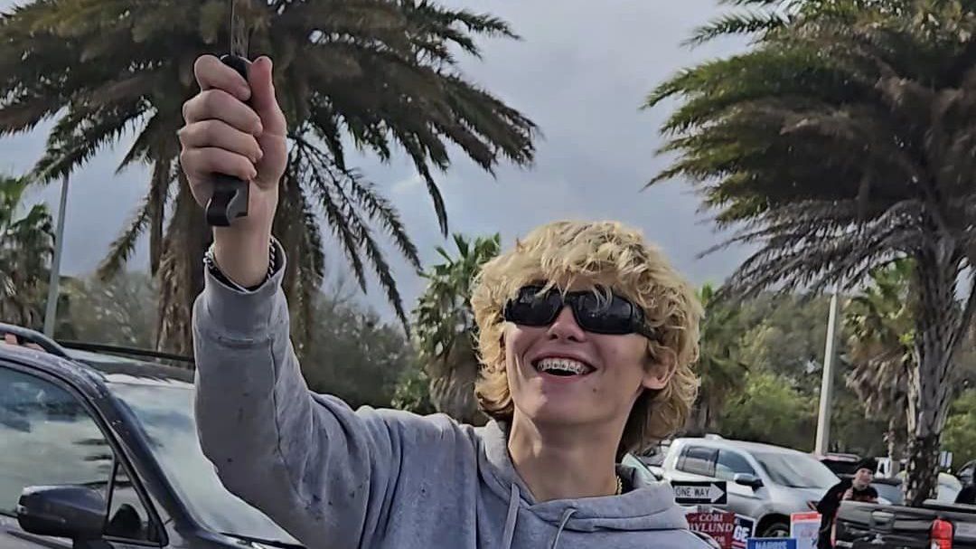 This image taken from video appears to show Caleb James Williams wielding a machete-style knife outside of a polling location in Neptune Beach, Fla., on Tuesday. (Neptune Beach Police Department)