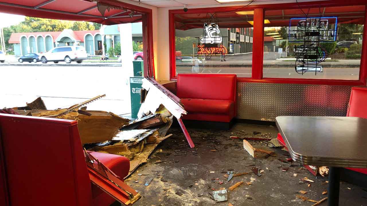Damage done to the dining room of Mel's Hot Dogs in Tampa by a car which struck the building following a collision outside on Busch Boulevard, Thursday, Oct. 31, 2019. (Laurie Davison/Spectrum Bay News 9)