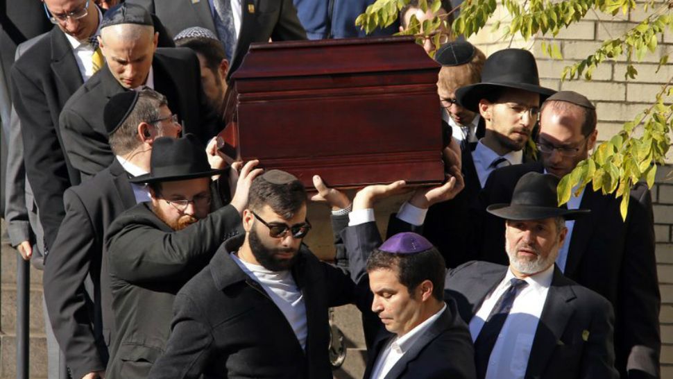 Pallbearers carry the casket of Joyce Fienberg after a funeral service Wednesday, Oct. 31, 2018, in Pittsburgh. A total of 11 people died in the weekend synagogue shootings. (AP Photo/Gene J. Puskar)