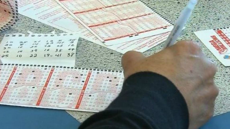 Man filling out Mega Millions betting slips