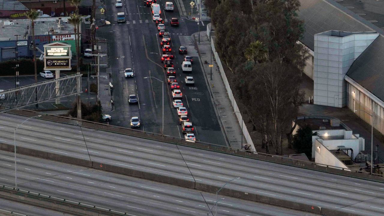 Motorists wait for a signal to change near a section of Interstate 10 that has been closed due to a fire in Los Angeles on Tuesday. (AP Photo/Jae C. Hong)