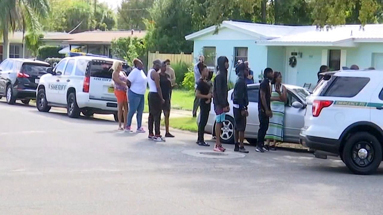 Community members gather around after Brevard County deputies shot and killed two teens after one of them drove towards the law enforcement officers, according to Sheriff Wayne Ivey. (Greg Pallone/Spectrum News 13)
