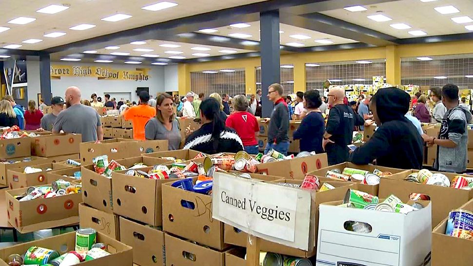 Volunteers sort food into about 2,000 boxes and then deliver those boxes to families in Ocoee, Apopka and parts of Orlando. (Spectrum News 13)