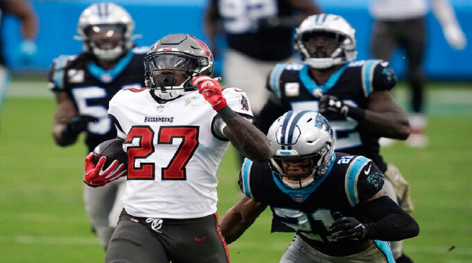 Tampa Bay Buccaneers running back Ronald Jones (27) runs for a 98-yard touchdown against the Carolina Panthers during the second half of an NFL football game, Sunday, Nov. 15, 2020, in Charlotte , N.C. (AP Photo/Gerry Broome)