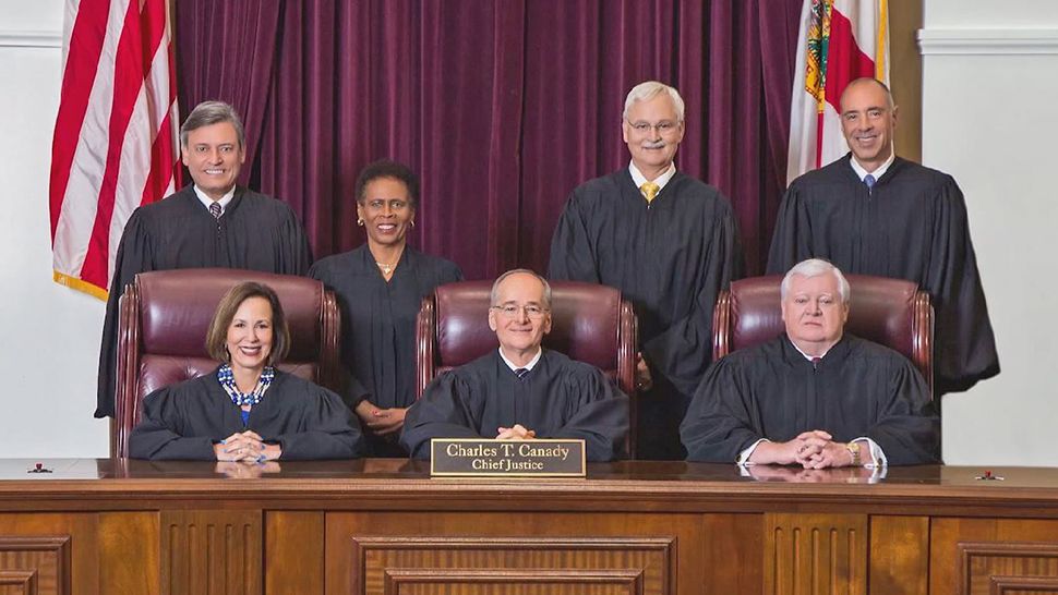 Florida Supreme Court justices Barbara Pariente, bottom left, Peggy Quince and Fred Lewis, furtherest from the right, sitting, are set to retire. (Florida Surpeme Court)