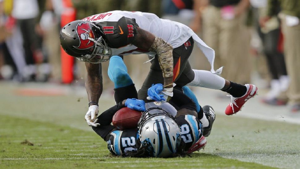 Carolina Panthers defensive back Donte Johnson (26) intercepts a pass intended for Bucs wide receiver DeSean Jackson, as Tampa Bay fell to Carolina 42-28 last week to drop to 3-5 this season. (AP Photo/Neil Redmond)