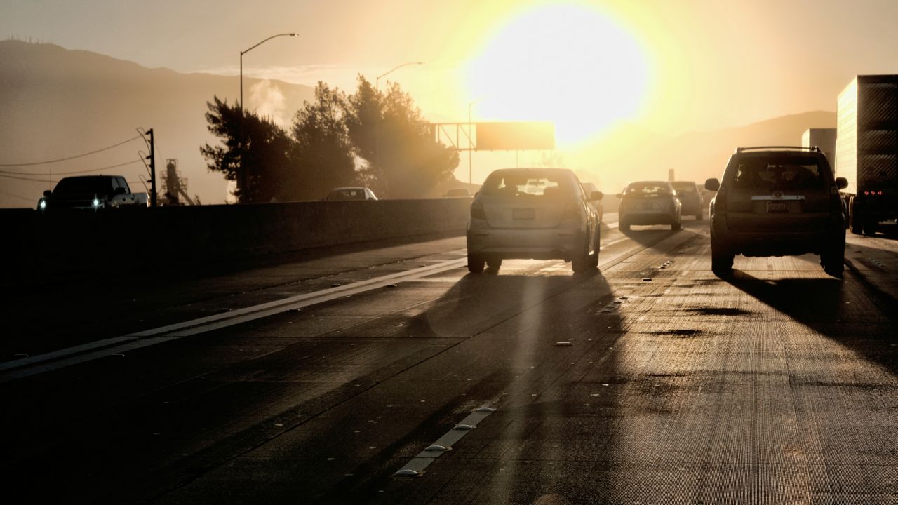 Commuters drive into downtown Los Angeles as the sun rises along Interstate 5. (AP Photo/Richard Vogel)