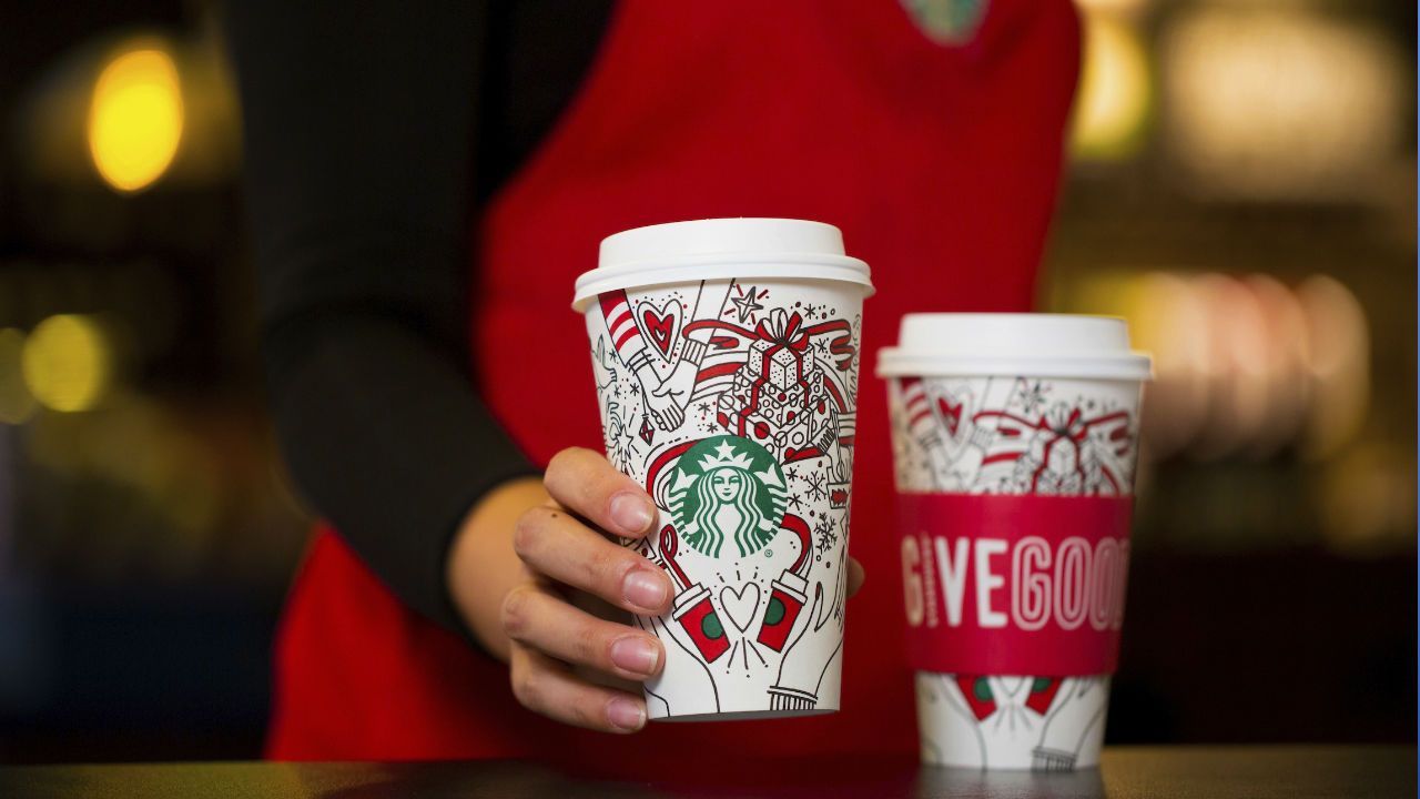This Monday, Oct. 23, 2017, photo provided by Starbucks shows the company's 2017 holiday cup on display in Seattle. This latest holiday cup is mostly white, for customers to color in themselves. (Joshua Trujillo/Starbucks via AP)