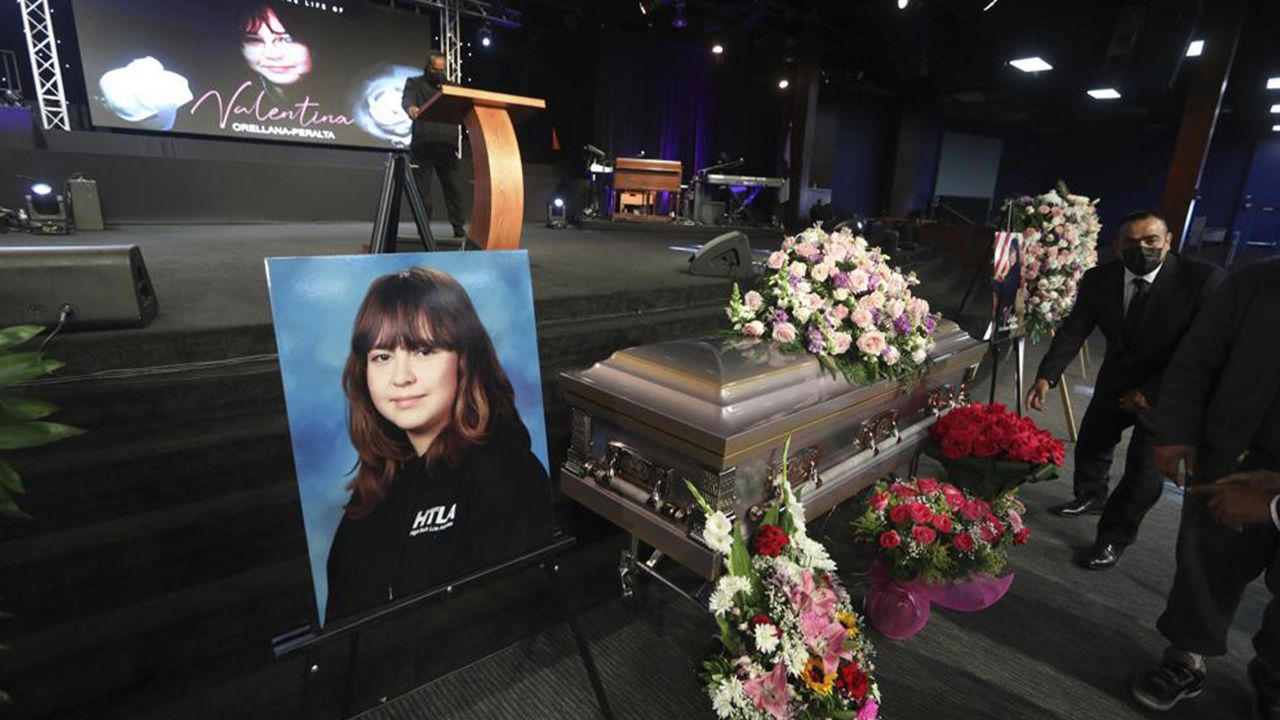 The casket containing 14-year-old Valentina Orellana Peralta, killed on Dec. 23, 2021 by a LAPD police officer's stray bullet while shopping with her mother, is readied for her funeral at the City of Refuge Church in Gardena, Calif., Monday, Jan. 10, 2022. (AP Photo/David Swanson)