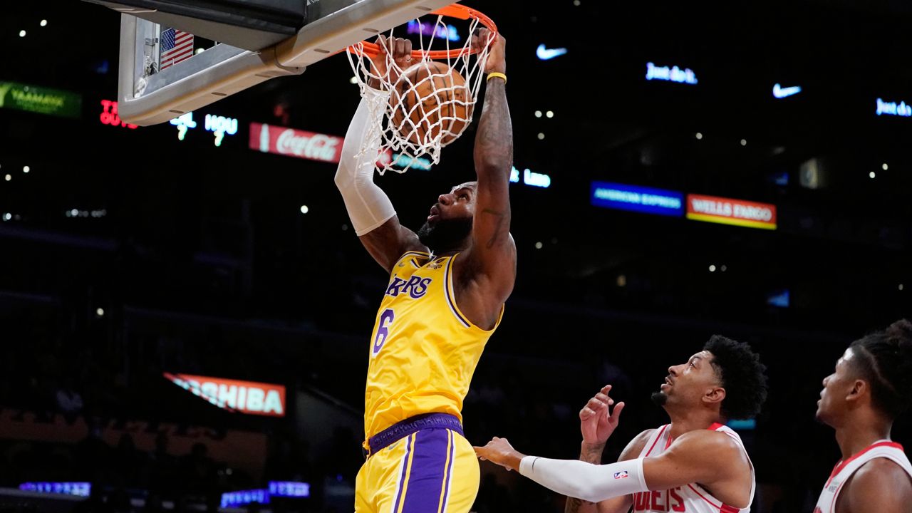 Los Angeles Lakers forward LeBron James (6) dunks past Houston Rockets center Christian Wood (35) during the first half of an NBA basketball game Tuesday, Nov. 2, 2021, in Los Angeles. (AP Photo/Marcio Jose Sanchez)