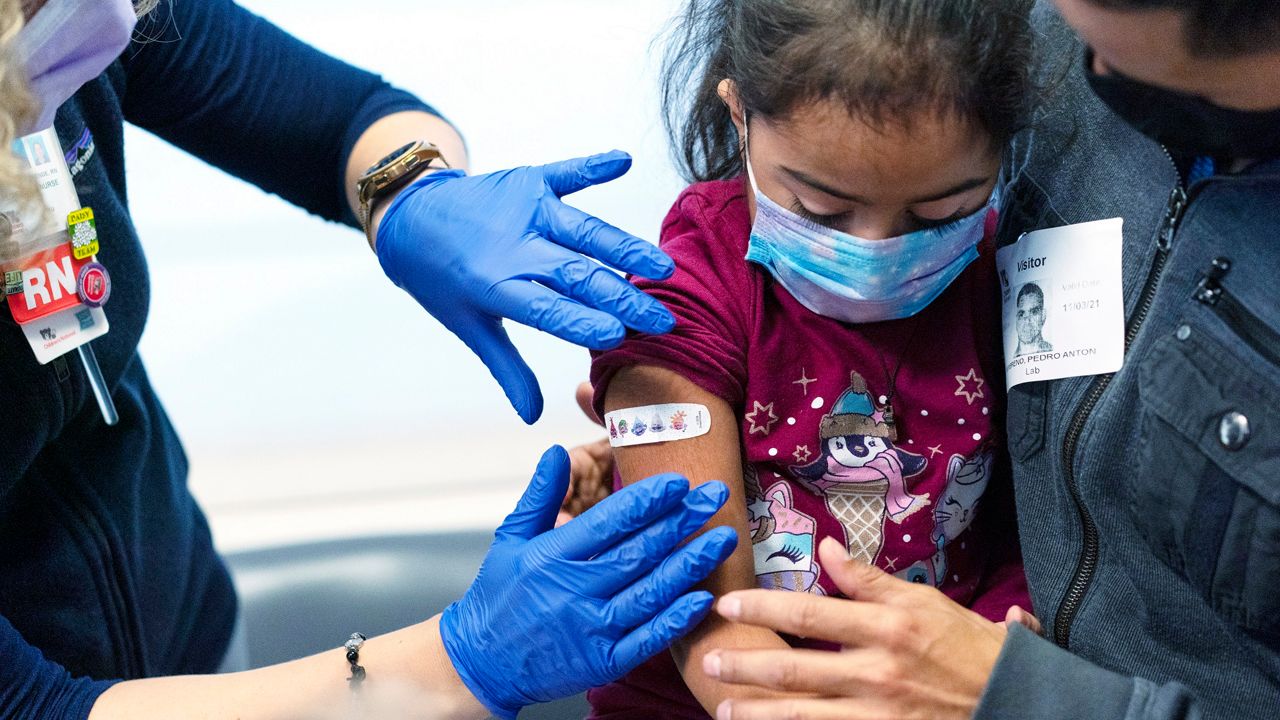 A girl receives the Pfizer-BioNTech COVID-19 vaccine. (AP Photo, File)