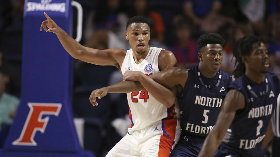 Florida forward Kerry Blackshear Jr. (24) looks for the ball against North Florida forward Dorian James (5) during the second half of an NCAA college basketball game Tuesday, Nov. 5, 2019, in Gainesville, Fla. (AP Photo/Matt Stamey)