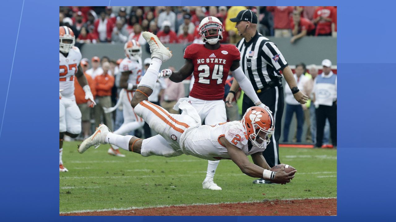 Clemson quarterback Kelly Bryant (2) dives into the end zone for a touchdown while North Carolina State's Shawn Boone (24) looks on during the first half of an NCAA college football game in Raleigh, N.C., Saturday, Nov. 4, 2017. (AP Photo/Gerry Broome)