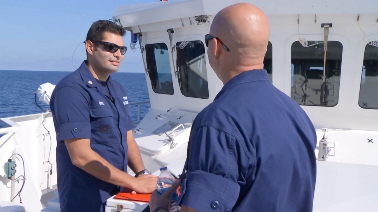 Petty Officer 2nd Class Luis Ortiz and Chief Petty Officer Jason Dame strategize before running a drill with the crew aboard the U.S. Coast Guard Cutter Paul Clark. 