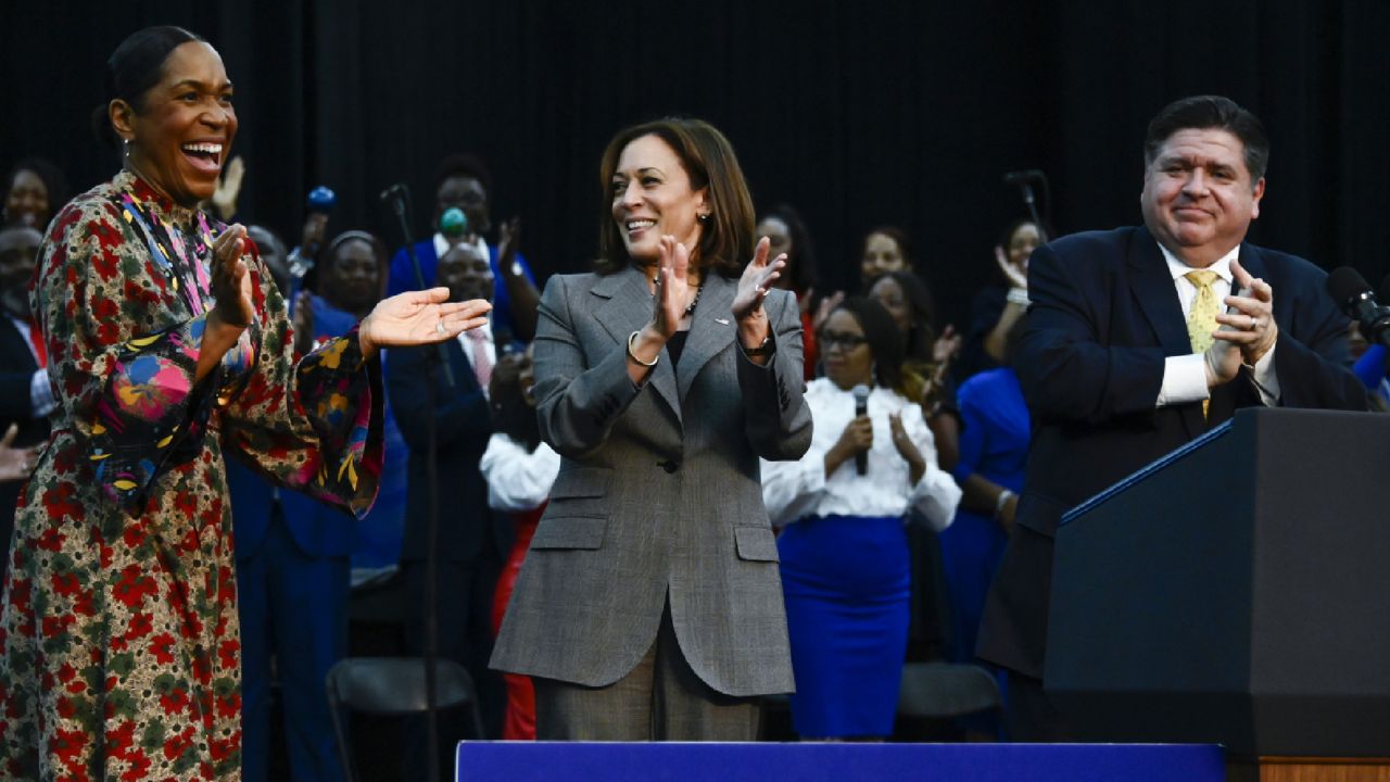 Vice President Kamala Harris, center, with Illinois Gov. J.B. Pritzker, right, and Illinois Lt. Gov. Juliana Stratton, left, stand on stage during a rally at XS Tennis and Education Foundation, Sunday, Nov. 6, 2022, in Chicago. (AP Photo/Matt Marton)