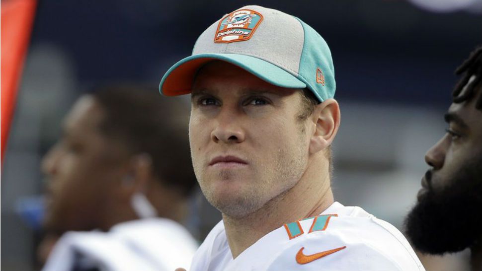 FILE - In this Sept. 30, 2018, file photo ,Miami Dolphins quarterback Ryan Tannehill watches from the sideline during the second half of an NFL football game against the New England Patriots in Foxborough, Mass. The Dolphins quarterback will rest his injured throwing shoulder for the next few days and has been ruled out of Sunday’s game at Green Bay, meaning replacement Brock Osweiler will make his fifth consecutive start. (AP Photo/Steven Senne, File)