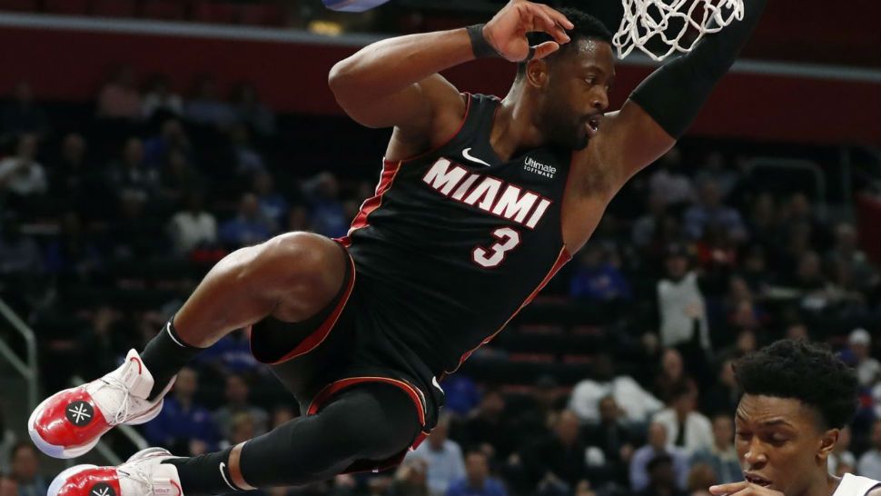 Detroit Pistons forward Stanley Johnson (7) reaches for the ball after a dunk by Miami Heat guard Dwyane Wade during the second half of an NBA basketball game, Monday, Nov. 5, 2018, in Detroit. (AP Photo/Carlos Osorio)