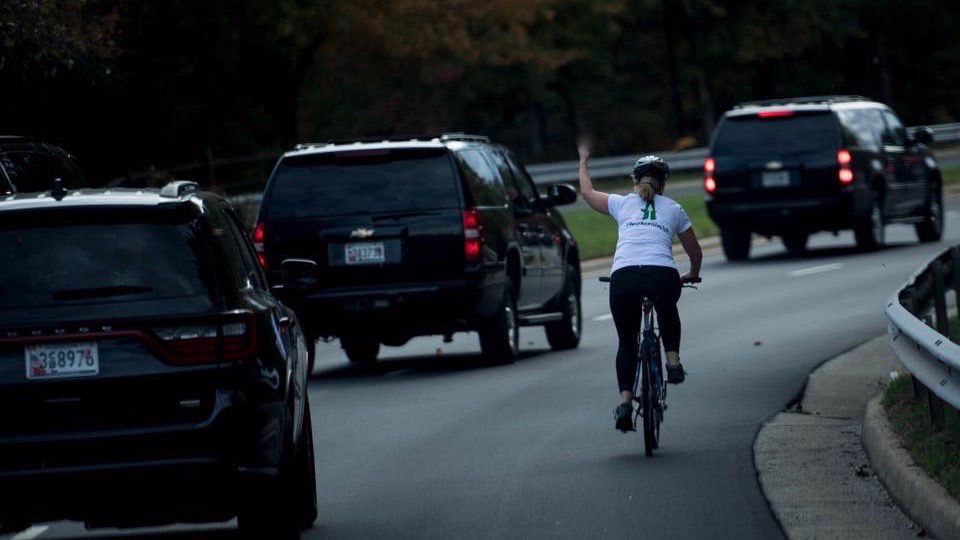 Juli Briskman flipping off the presidential motorcade