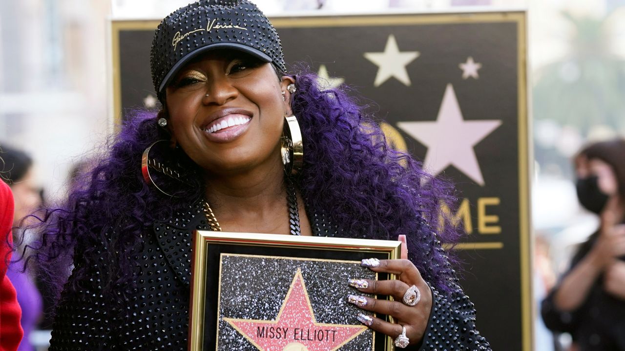 Hip hop artist Missy Elliott holds a replica of her new star on the Hollywood Walk of Fame during a ceremony for her, Monday, Nov. 8, 2021, in Los Angeles. (AP Photo/Chris Pizzello)