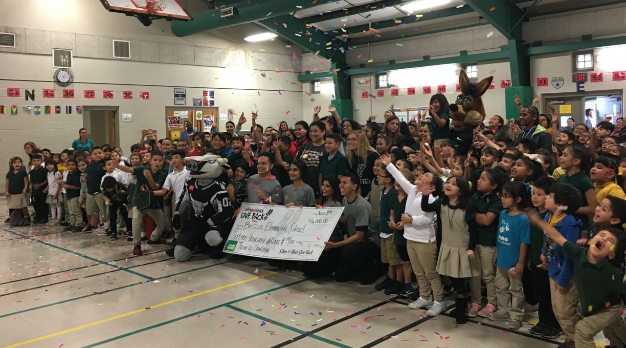 Students celebrate $16,000 check given from SBGB November 8, 2018 (Spectrum News)