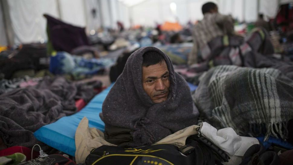 Alcides Padilla, from Honduras, wakes up at the Jesus Martinez stadium in Mexico City, Wednesday, November 7, 2018. Central American migrants on Wednesday continued to straggle in for a rest stop at a Mexico City stadium, where about 4,500 continue to weigh offers to stay in Mexico against the desire of many to reach the U.S. border. (AP Photo/Rodrigo Abd)
