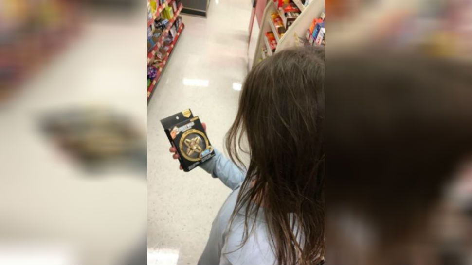 A girl staring at a fidget spinner